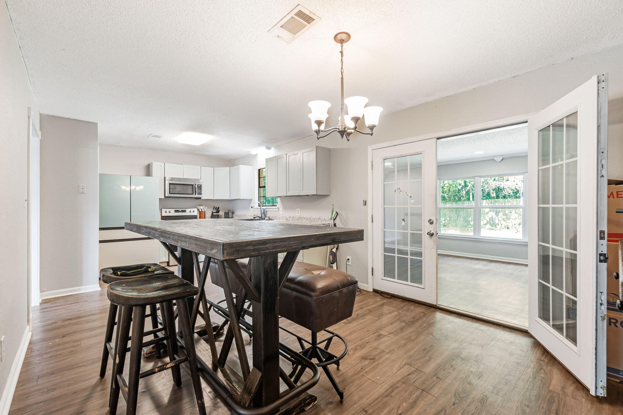 6517 Kennington Circle Milton, FL 32570 - Photo 16 of 37 a kitchen with stainless steel appliances kitchen island a table and chairs in it