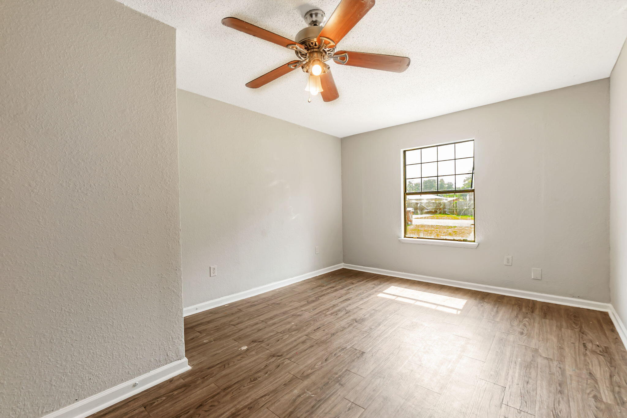 6517 Kennington Circle Milton, FL 32570 - Photo 18 of 37 wooden floor in an empty room with a window