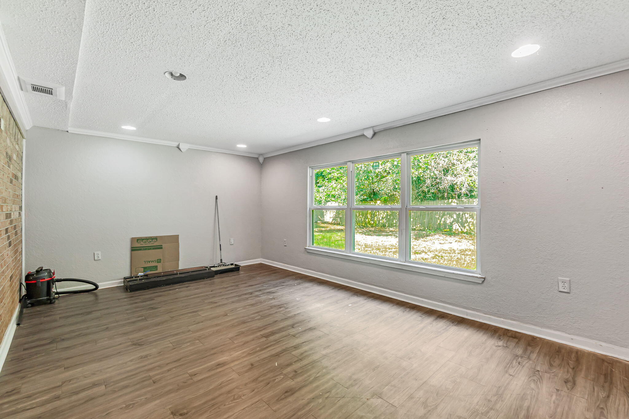 6517 Kennington Circle Milton, FL 32570 - Photo 20 of 37 an empty room with wooden floor and windows