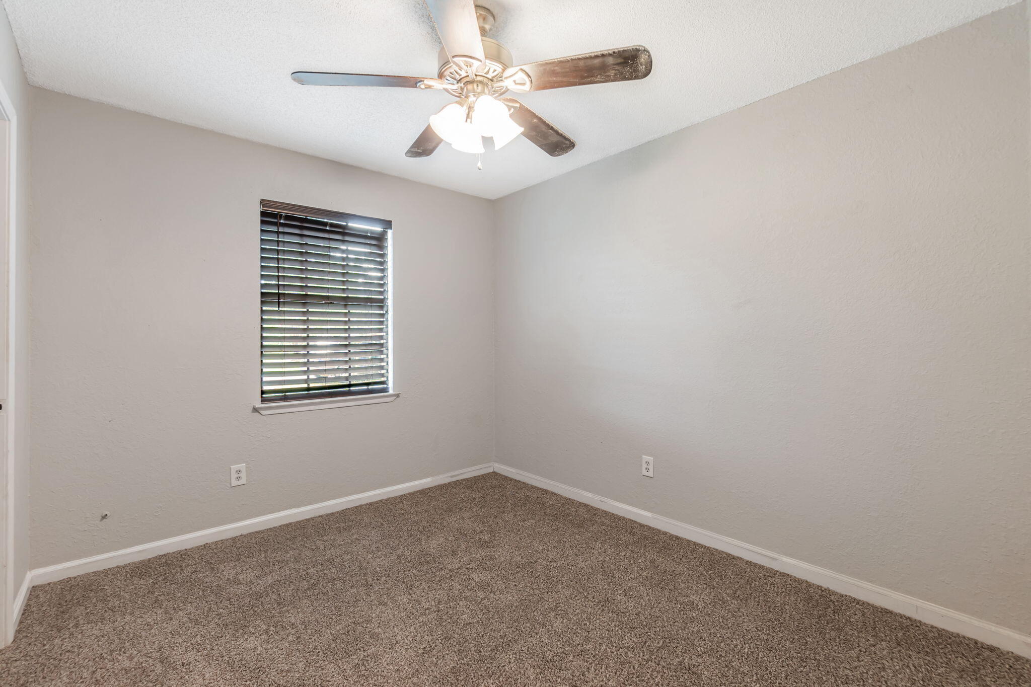 6517 Kennington Circle Milton, FL 32570 - Photo 24 of 37 an empty room with a window and a fan