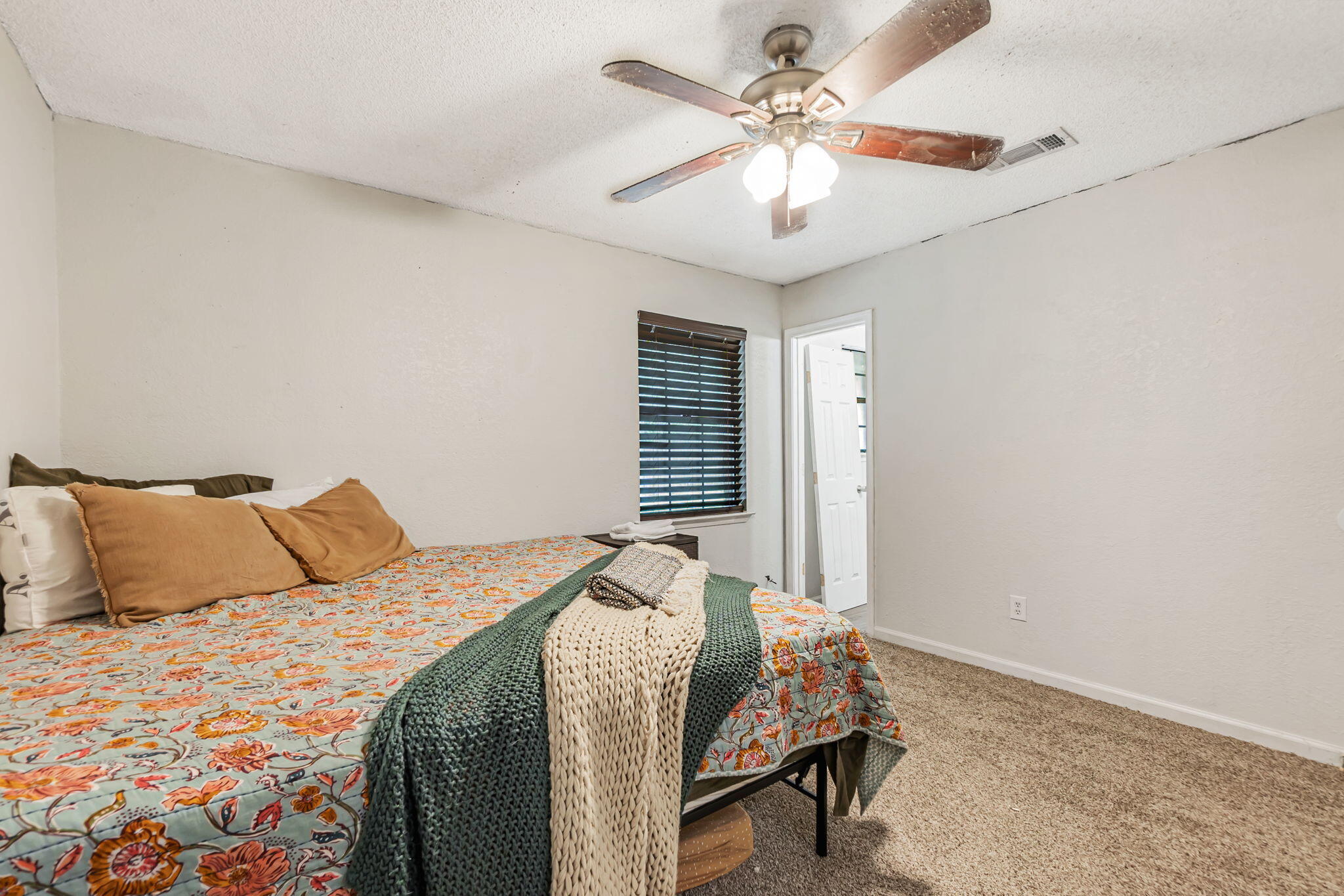 6517 Kennington Circle Milton, FL 32570 - Photo 26 of 37 a bedroom with a large bed and a chandelier