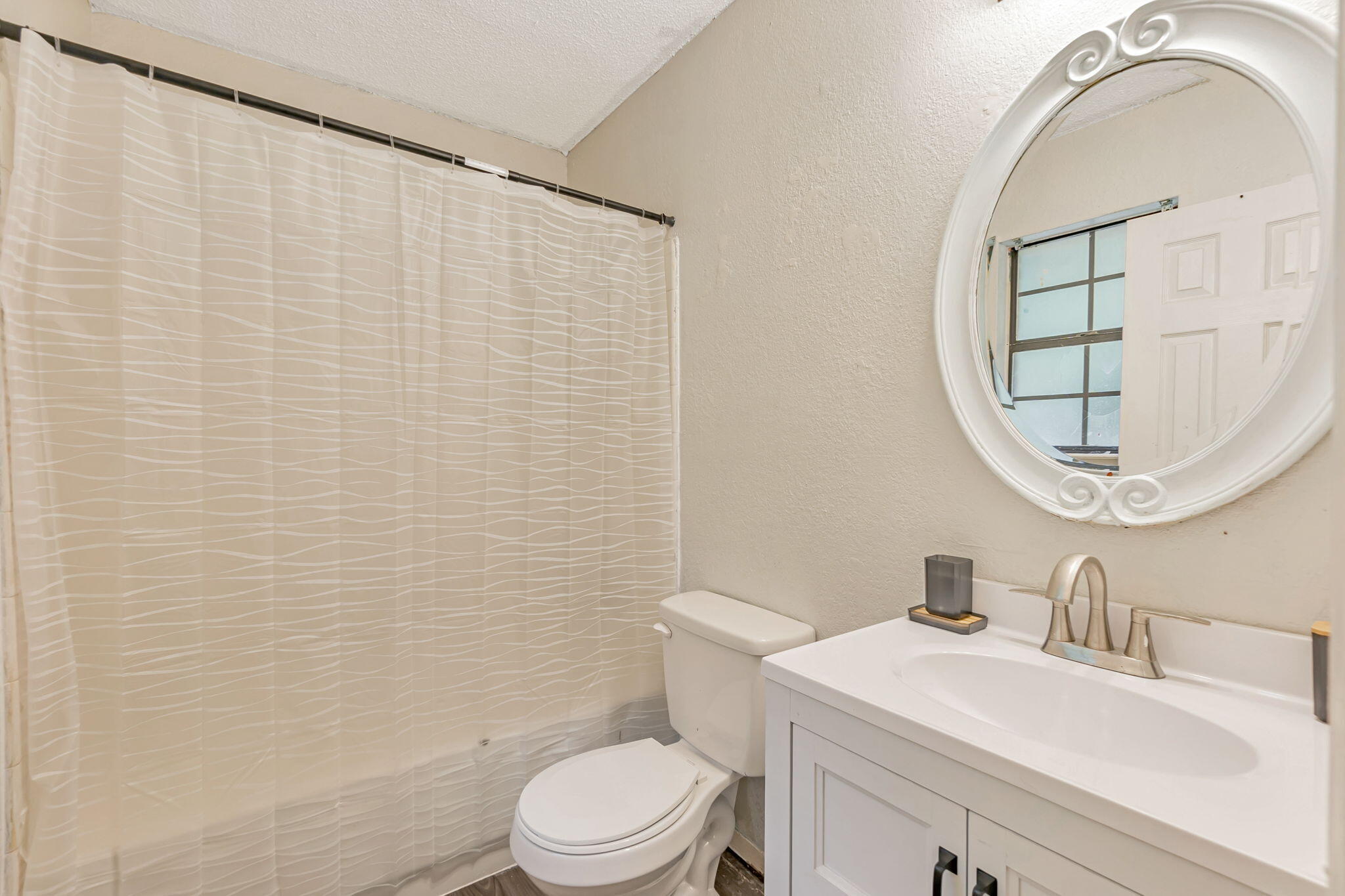 6517 Kennington Circle Milton, FL 32570 - Photo 29 of 37 a bathroom with a sink a toilet and a mirror