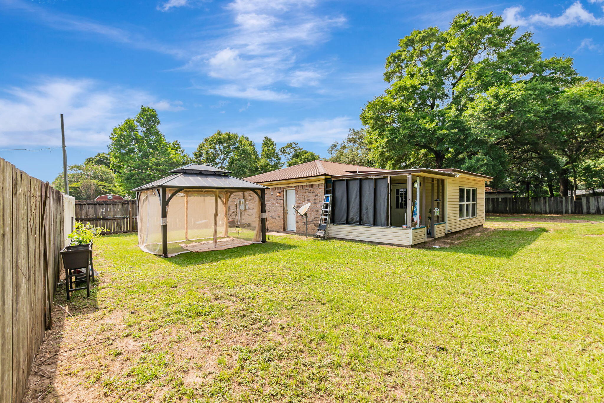 6517 Kennington Circle Milton, FL 32570 - Photo 32 of 37 a swimming pool with some trees in the background
