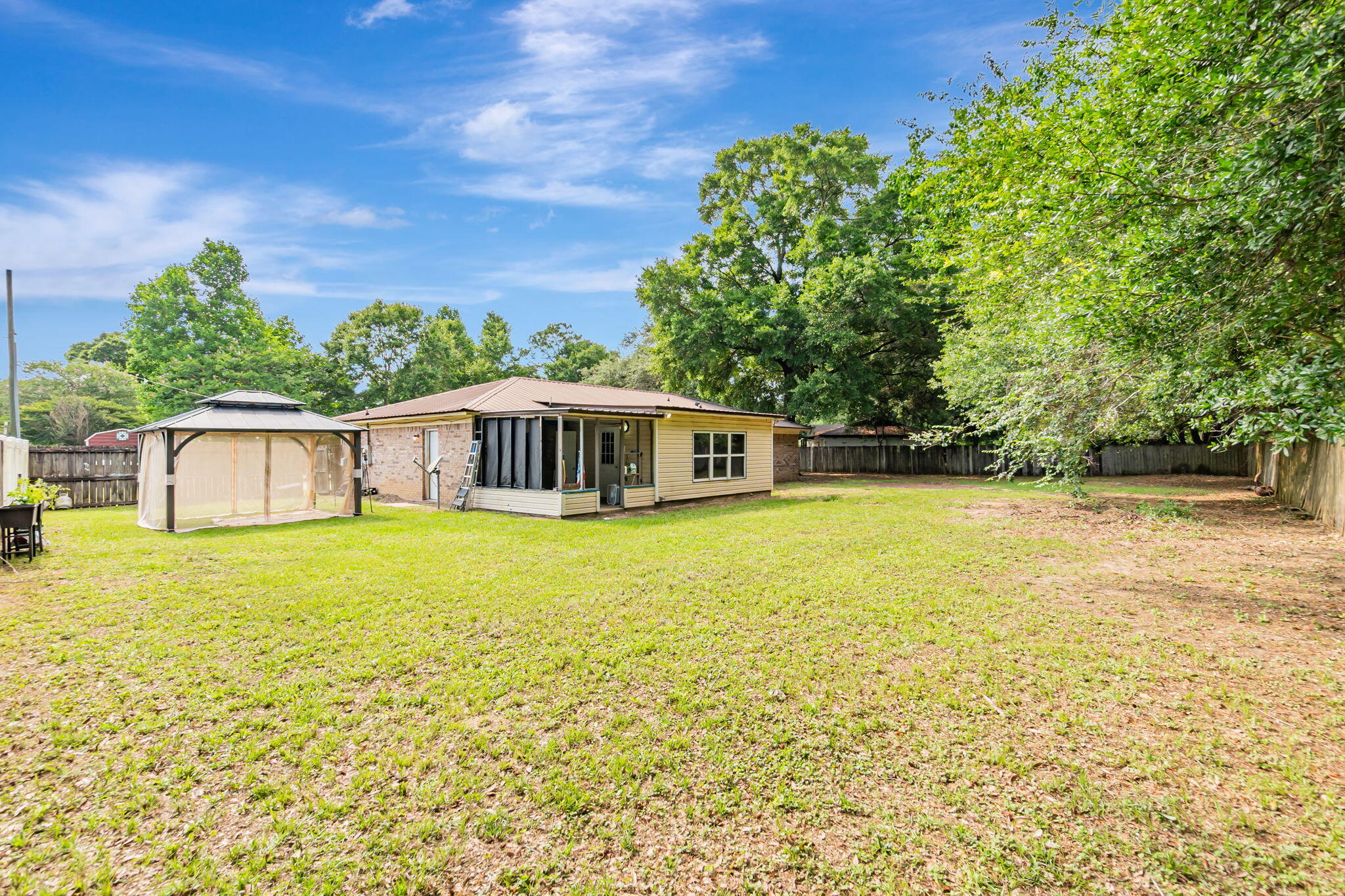 6517 Kennington Circle Milton, FL 32570 - Photo 33 of 37 a front view of a house with a garden
