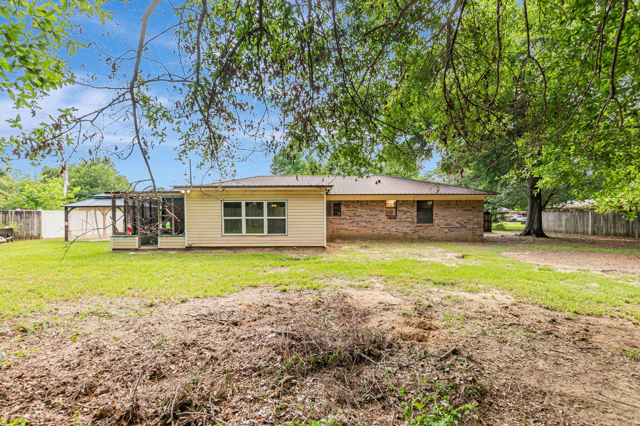 6517 Kennington Circle Milton, FL 32570 - Photo 34 of 37 a front view of a house with a garden and trees