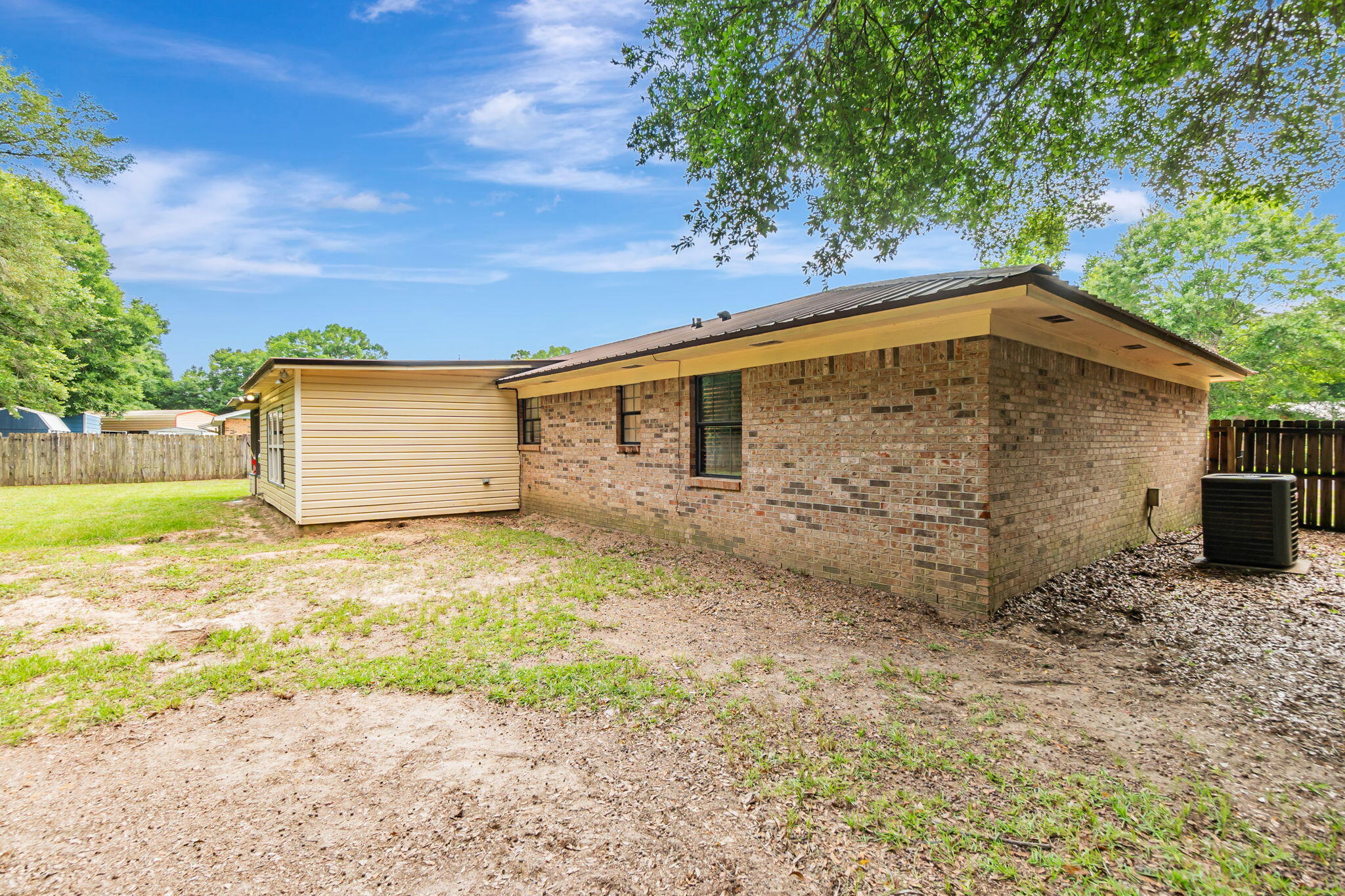 6517 Kennington Circle Milton, FL 32570 - Photo 37 of 37 a backyard of a house with a large tree