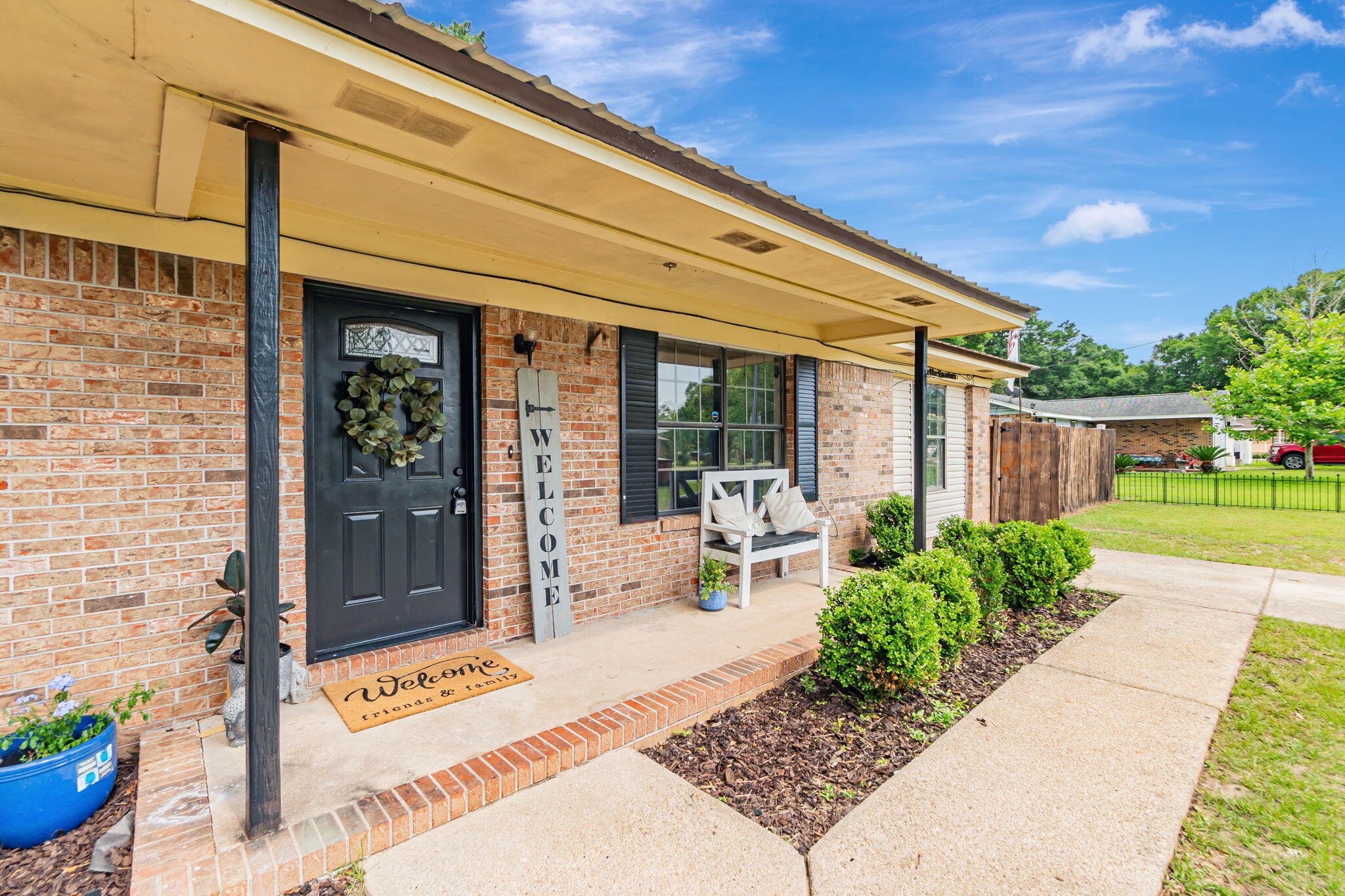 6517 Kennington Circle Milton, FL 32570 - Photo 6 of 37 a view of a patio with table and chairs potted plants with wooden fence