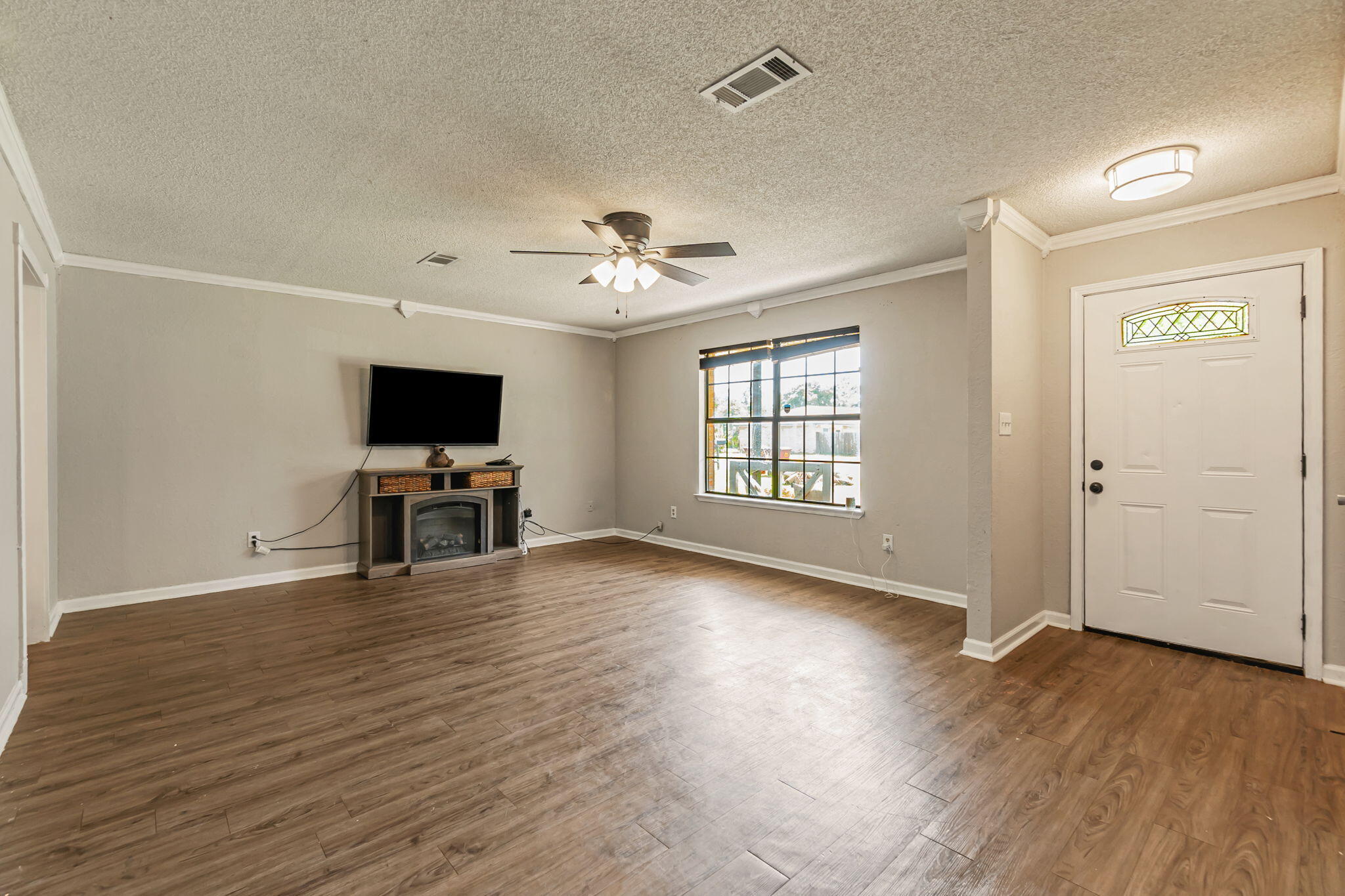 6517 Kennington Circle Milton, FL 32570 - Photo 8 of 37 an empty room with wooden floor and a window