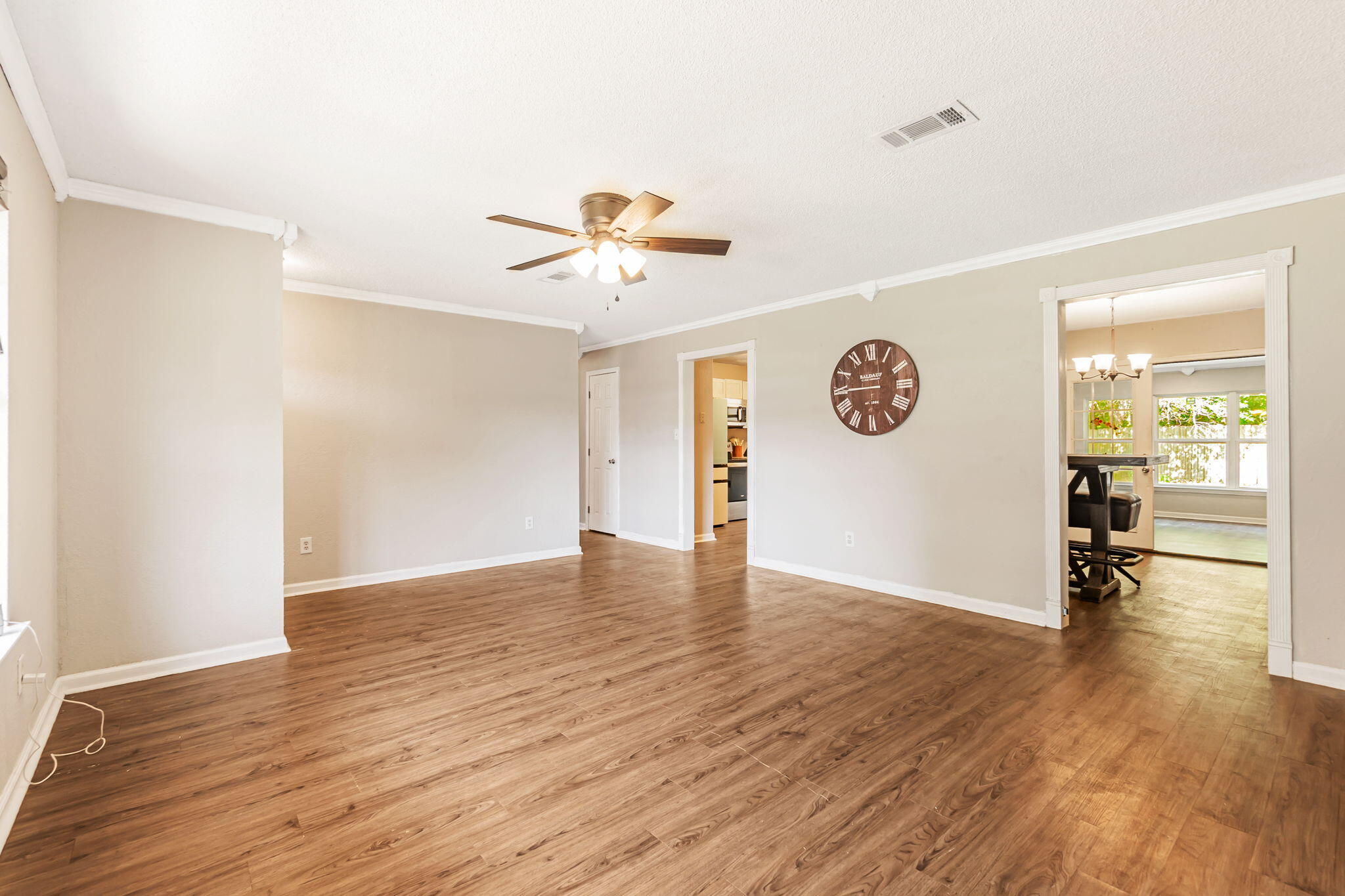6517 Kennington Circle Milton, FL 32570 - Photo 10 of 37 a view of an empty room with window and wooden floor