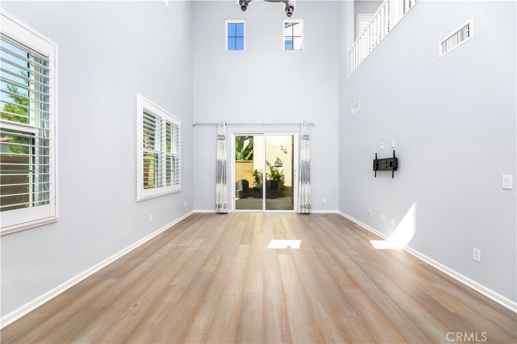 242 Firefly Irvine, CA 92618 - Photo 8 of 24 an empty room with wooden floor and windows