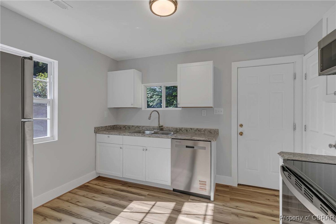 830 Glebe Road Mathews, VA 23109 - Photo 3 of 17 a kitchen with a sink cabinets and a window