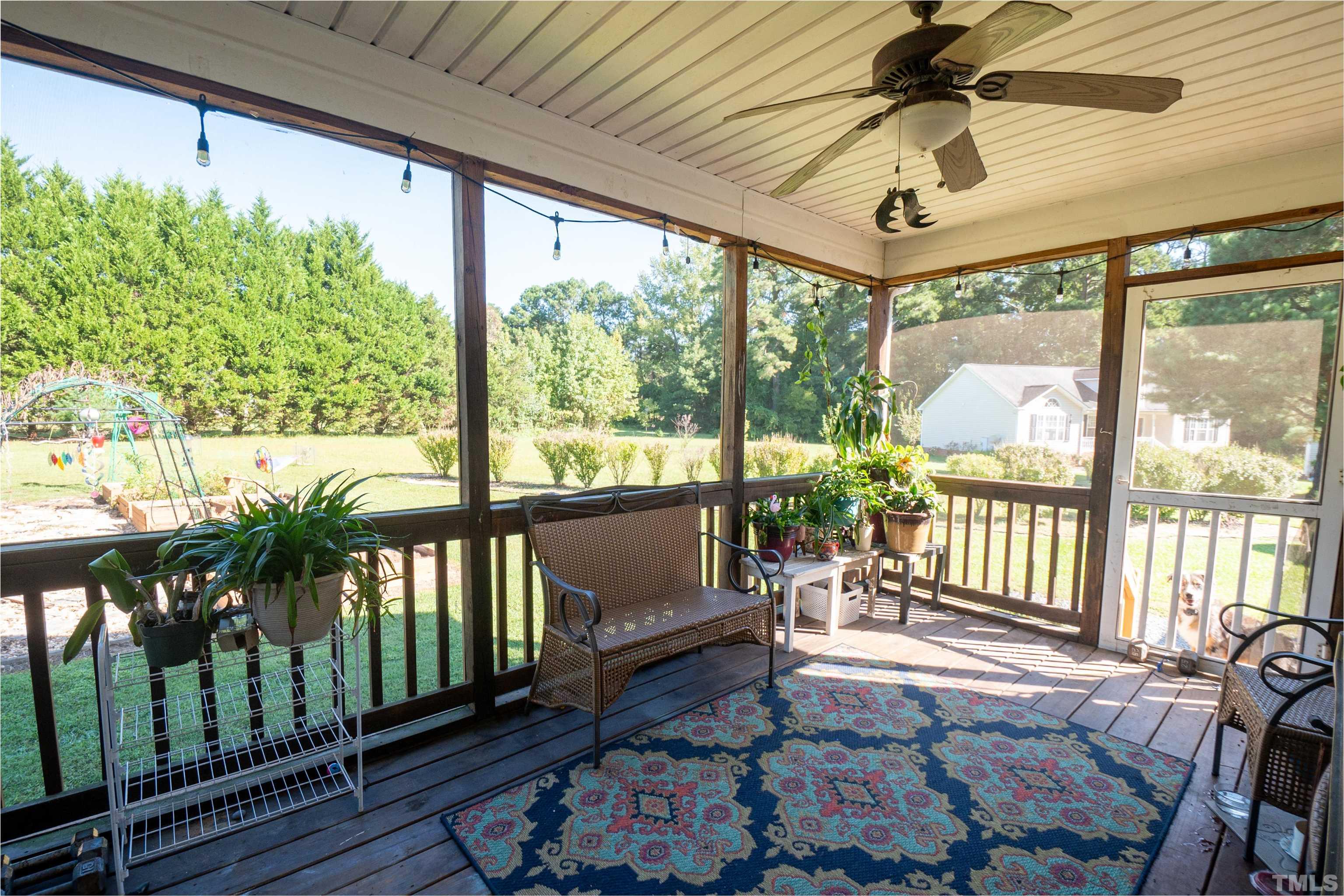 128 Edmondson Drive Willow Spring, NC 27592 - Photo 15 of 24 a view of a porch with furniture and wooden floor