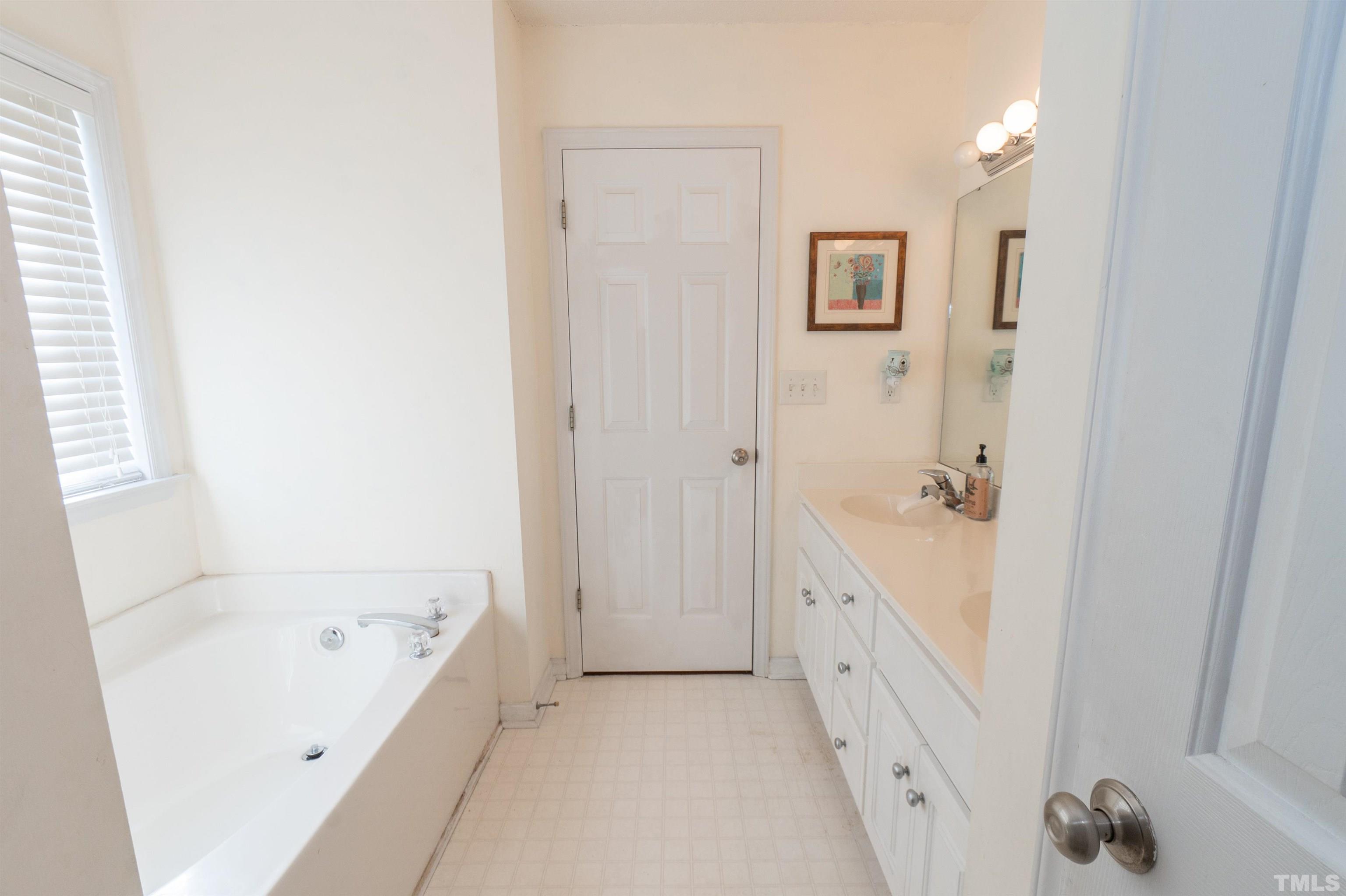 128 Edmondson Drive Willow Spring, NC 27592 - Photo 19 of 24 a bathroom with a bathtub and a sink