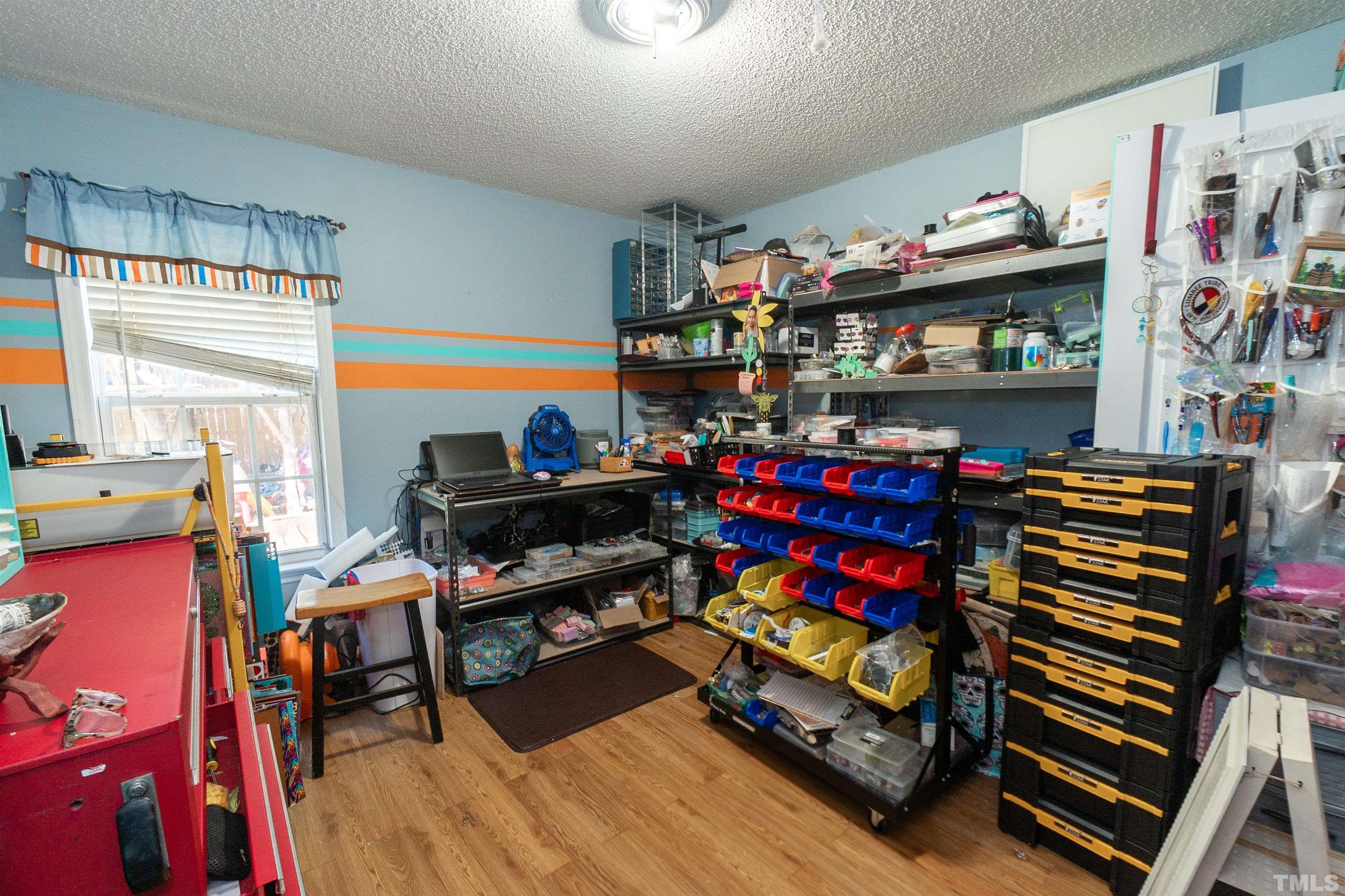 128 Edmondson Drive Willow Spring, NC 27592 - Photo 20 of 24 a living room with lots of furniture and a wooden floor
