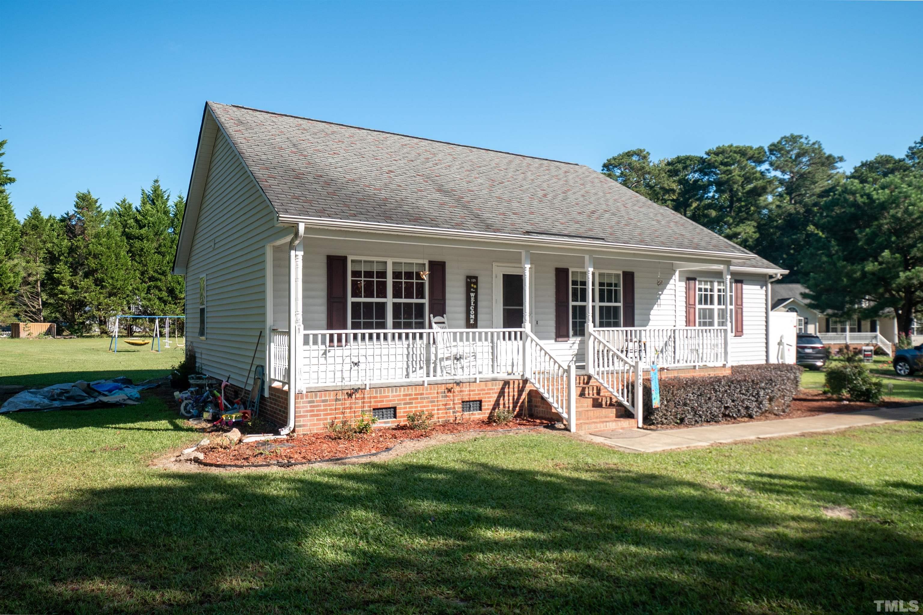 128 Edmondson Drive Willow Spring, NC 27592 - Photo 2 of 24 a view of a house with a yard and sitting area