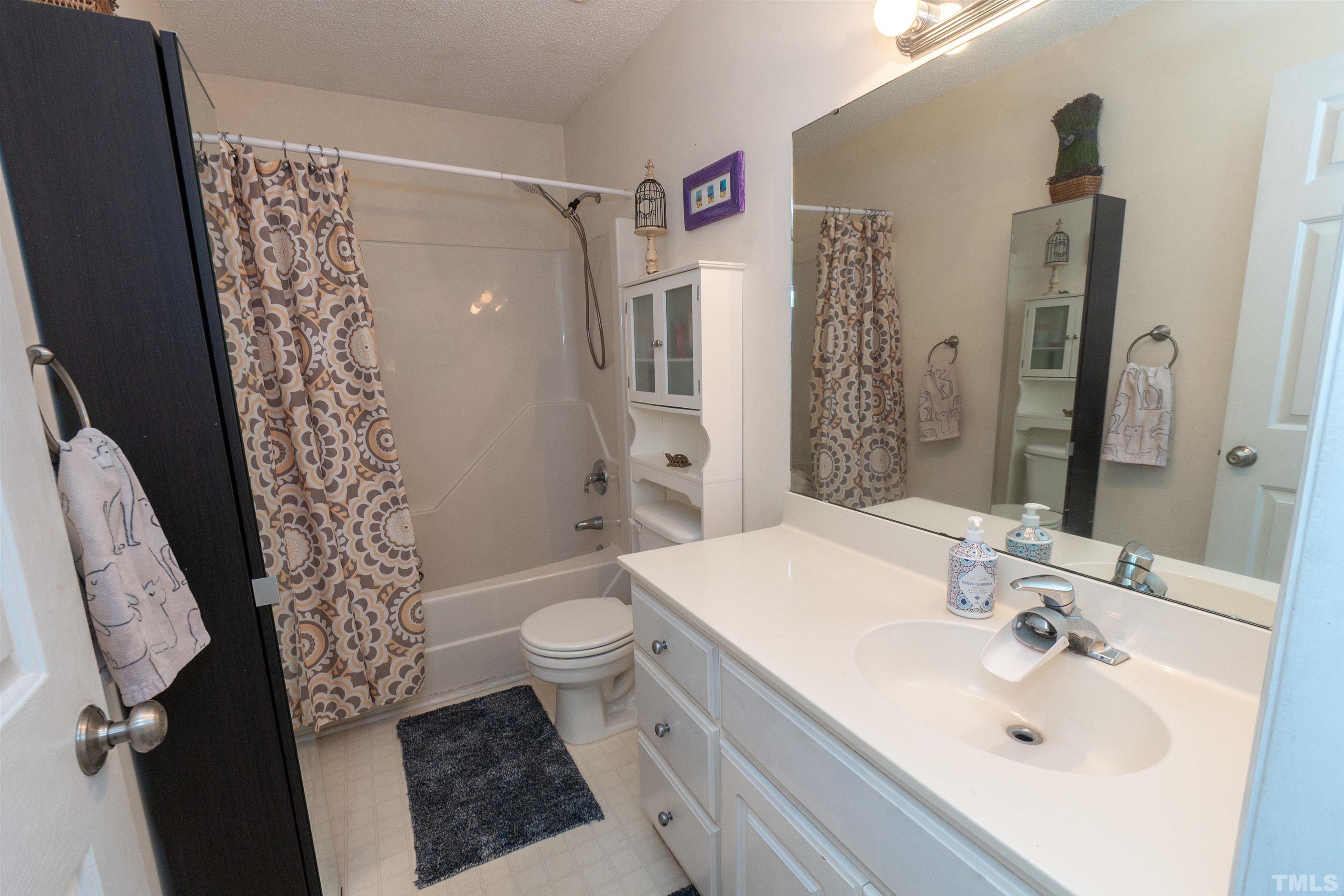 128 Edmondson Drive Willow Spring, NC 27592 - Photo 21 of 24 a bathroom with a sink toilet and shower