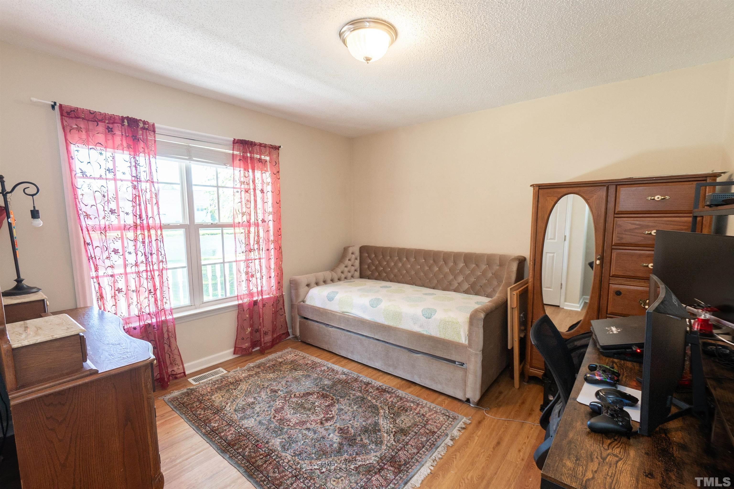 128 Edmondson Drive Willow Spring, NC 27592 - Photo 22 of 24 a living room with furniture and a window