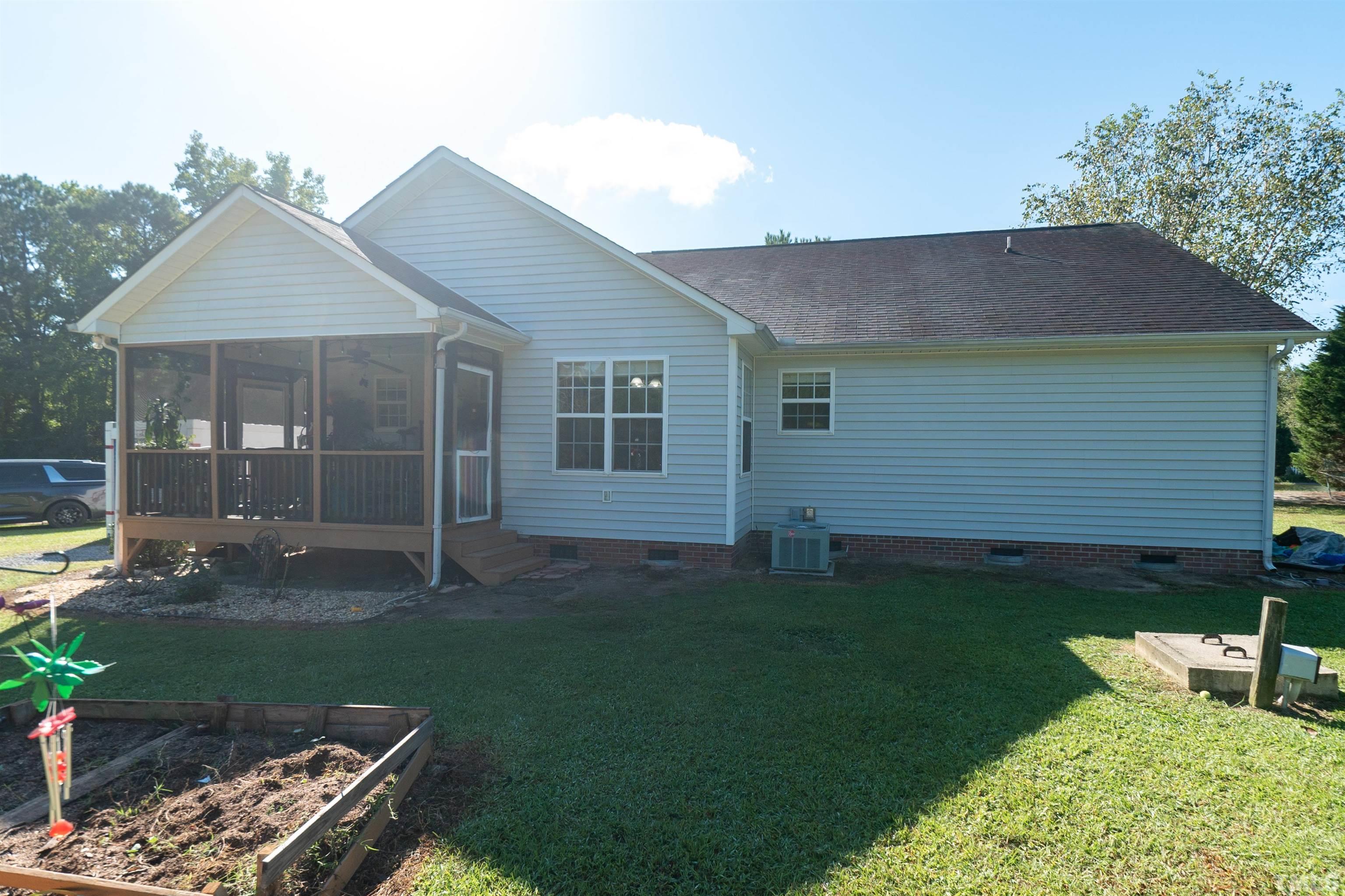 128 Edmondson Drive Willow Spring, NC 27592 - Photo 24 of 24 a backyard of a house with lots of green space