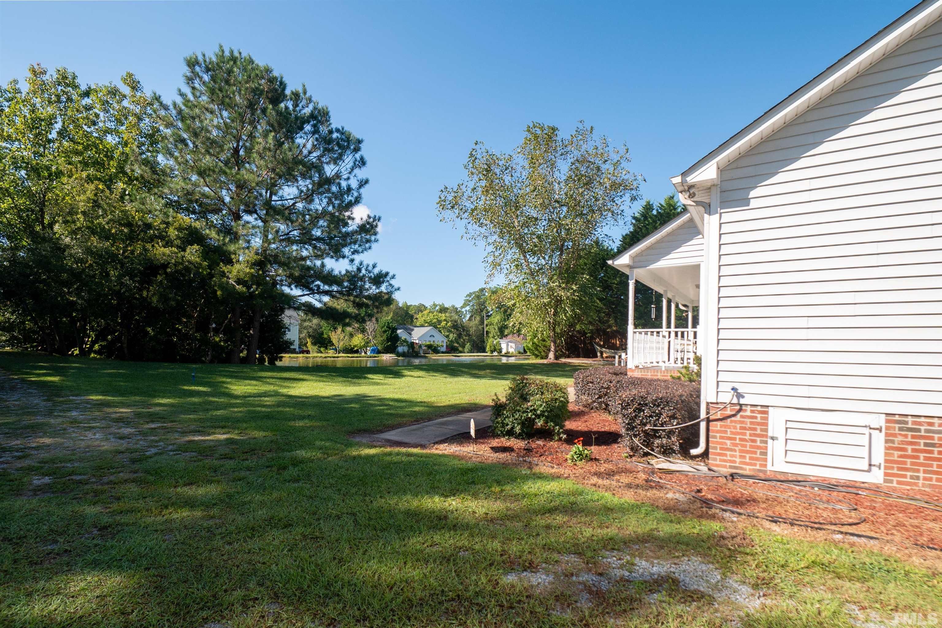 128 Edmondson Drive Willow Spring, NC 27592 - Photo 4 of 24 a view of a house with backyard sitting area and garden