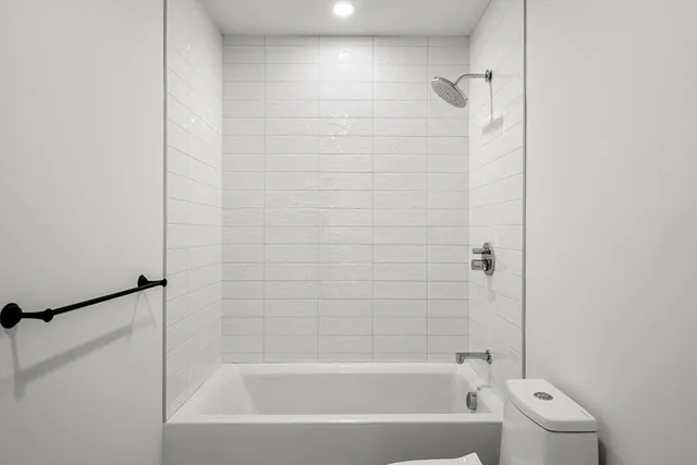 a bathroom with a bathtub and a shower