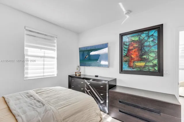 a bedroom that has a bed and a window