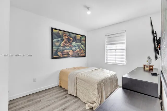 a bedroom with a bed and a couch