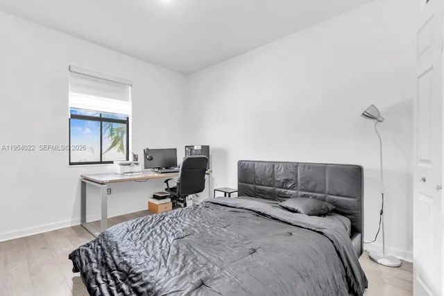 a bedroom with a bed and a desk