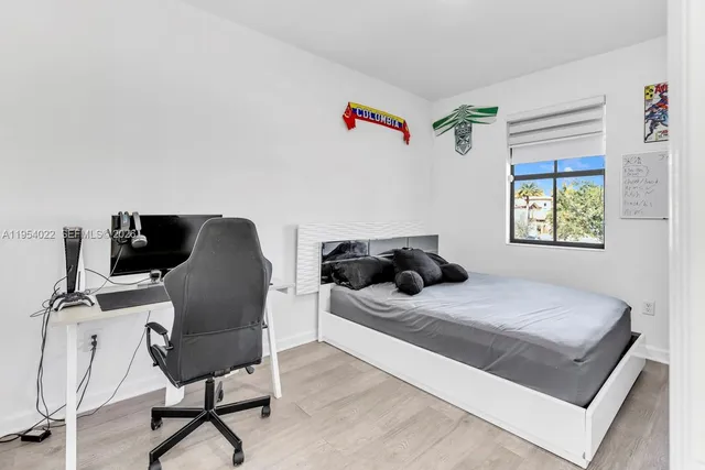 a bedroom with a bed and a chair