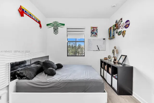 a bedroom with a bed and a window