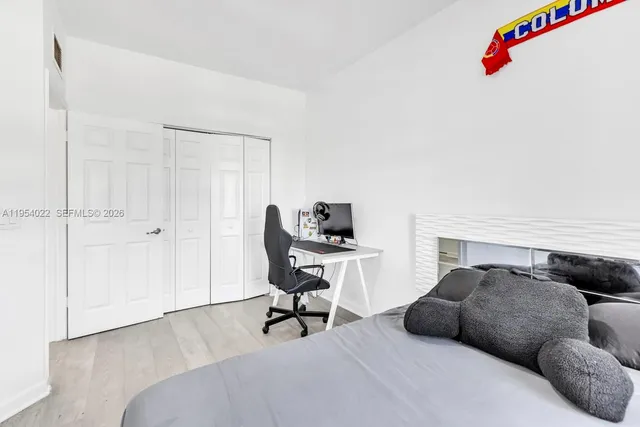 a bedroom with a bed and a chair