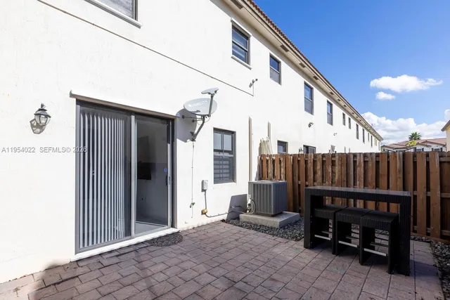 a view of a chair and tables in the balcony