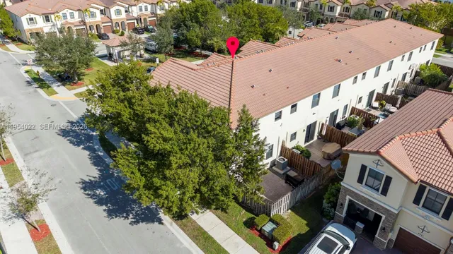 an aerial view of a house with a garden and plants