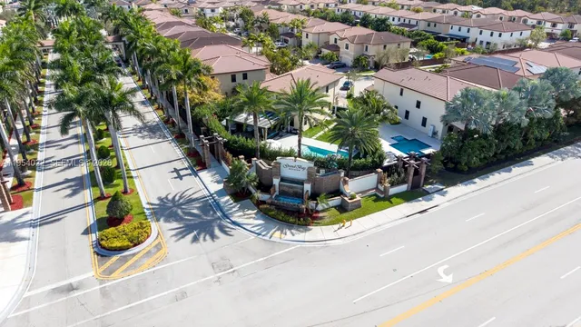 an aerial view of a house with garden space and street view