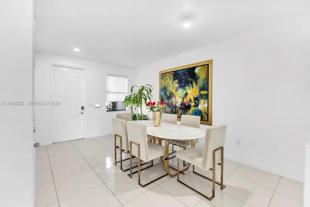 a view of a dining room with furniture and a potted plant