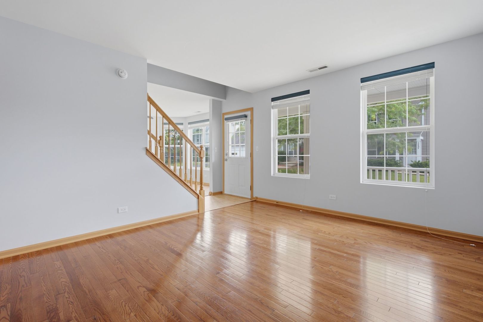 1758 Edith Lane Aurora, IL 60504 - Photo 4 of 28 a view of an empty room with wooden floor and a window