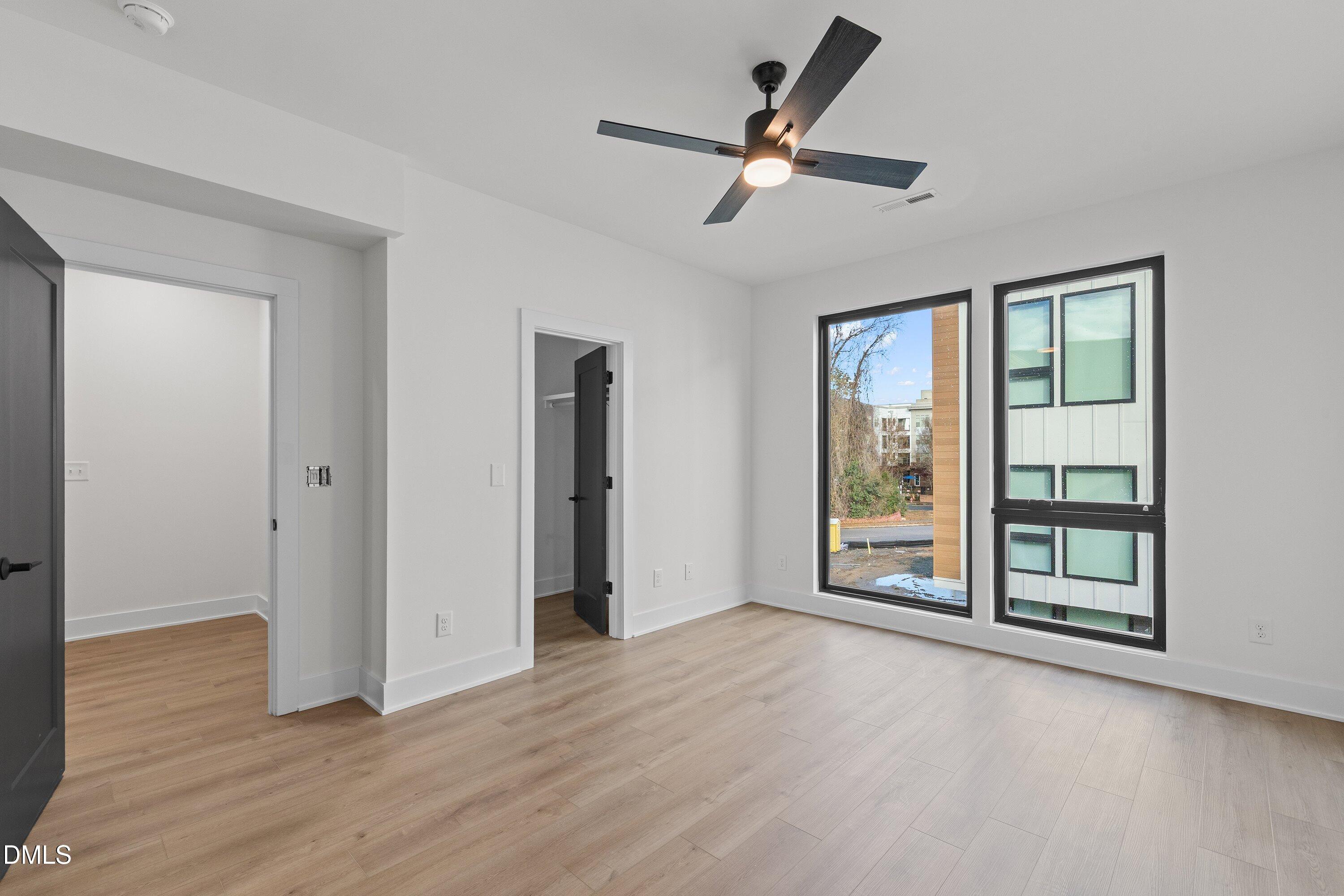 512 Gordon Street, Unit 901 Durham, NC 27701 - Photo 15 of 30 an empty room with wooden floor fan and windows