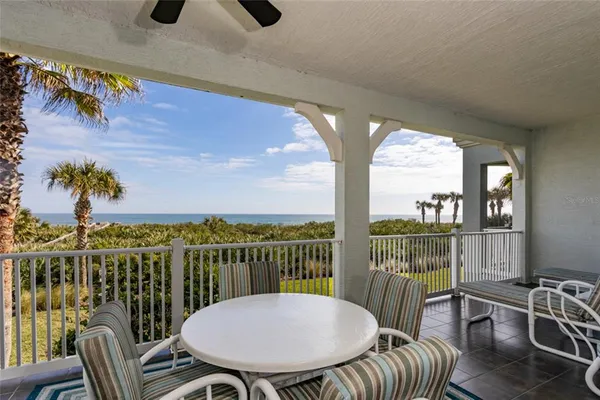 a view of a balcony with table and chairs