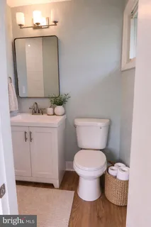a bathroom with a toilet sink and mirror