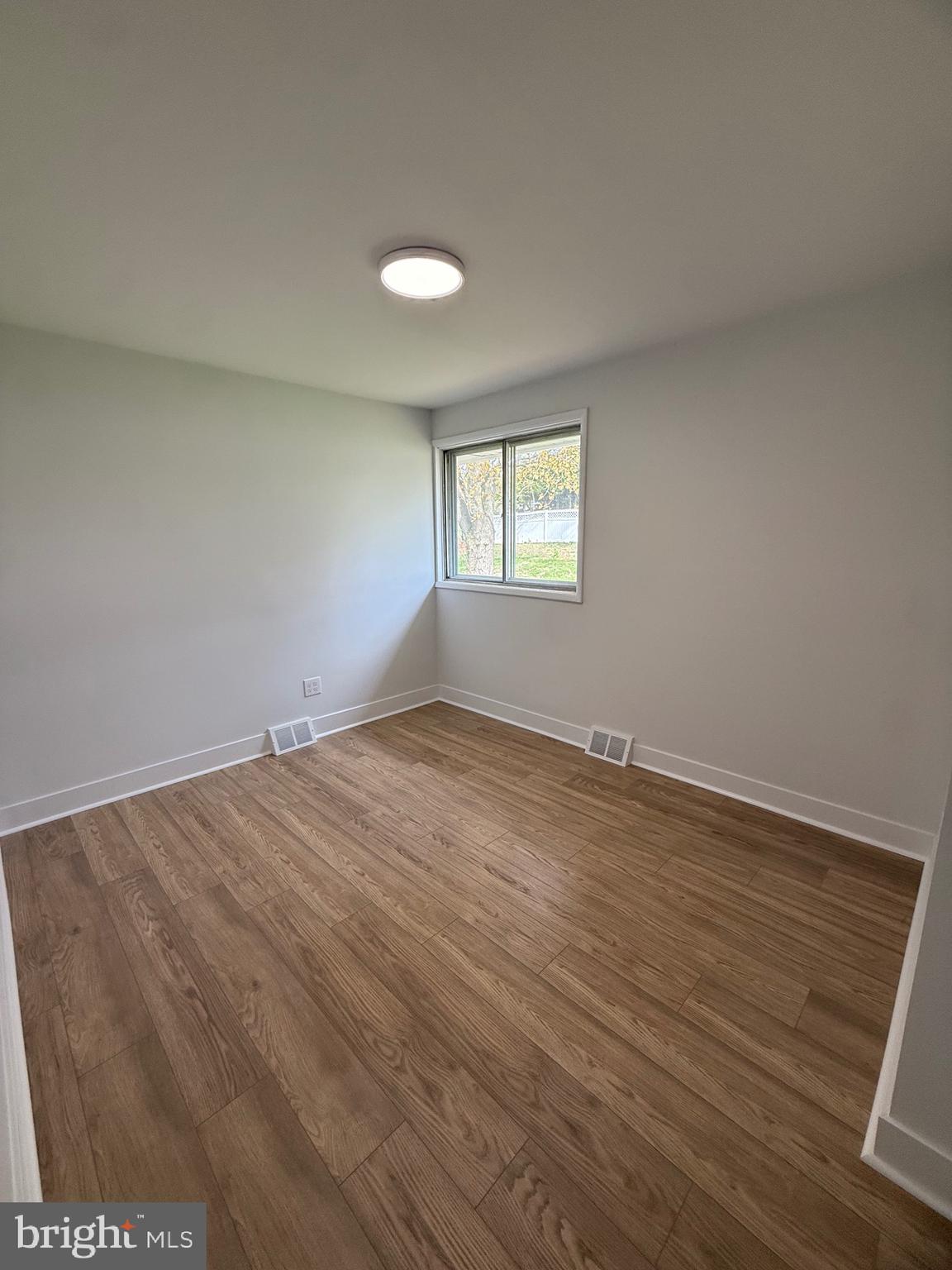 700 Fraser Road Glenside, PA 19038 - Photo 35 of 46 an empty room with wooden floor and windows