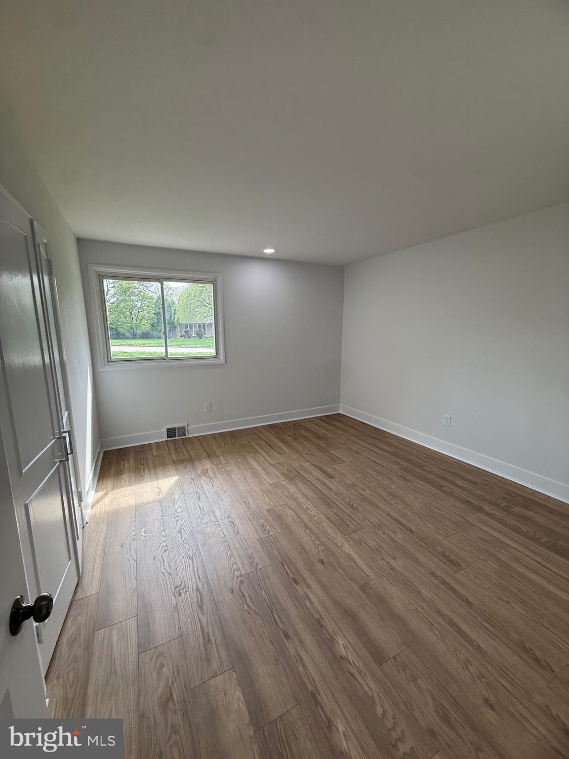 700 Fraser Road Glenside, PA 19038 - Photo 36 of 46 an empty room with wooden floor and windows