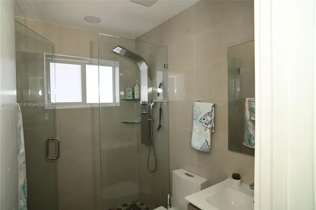 a bedroom with a bed and flat screen tv