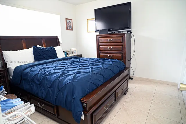 a bedroom with a bed and a dresser