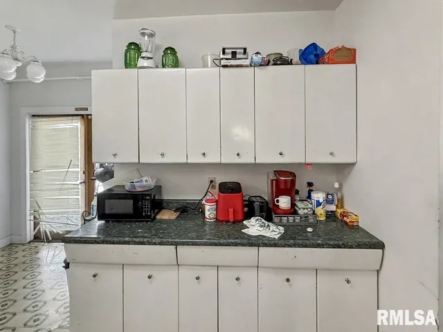 a kitchen with granite countertop cabinets and white appliances