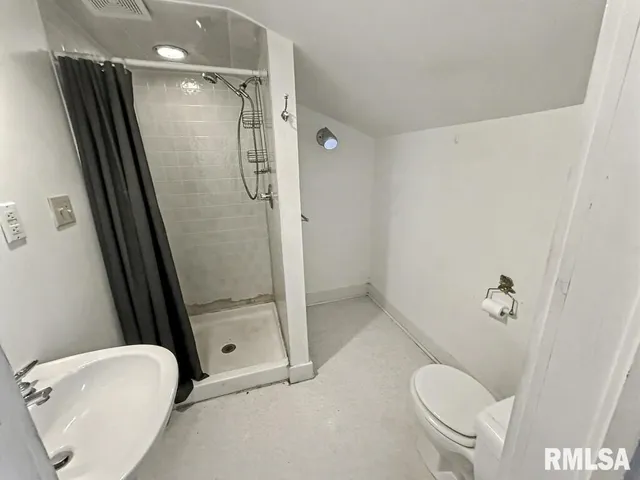 a bathroom with a shower and toilet