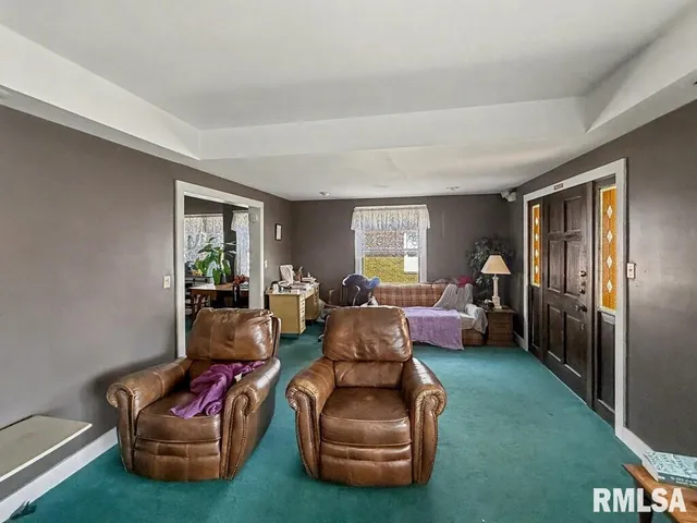 a living room with furniture window and wooden floor