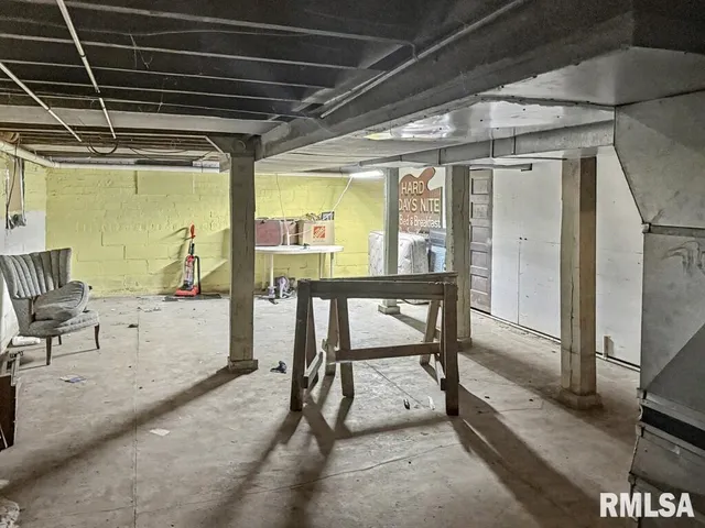 a view of a porch with furniture and a gate