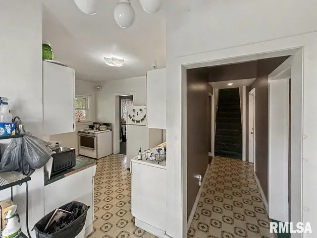a view of a hallway to a livingroom and a couch