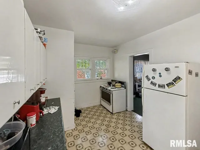 a kitchen with a refrigerator and a stove