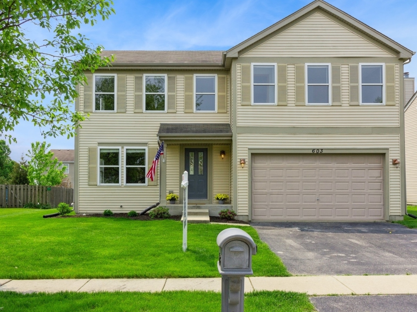603 Kennedy Street Waterman, IL 60556 - Photo 1 of 25 a front view of a house with garden