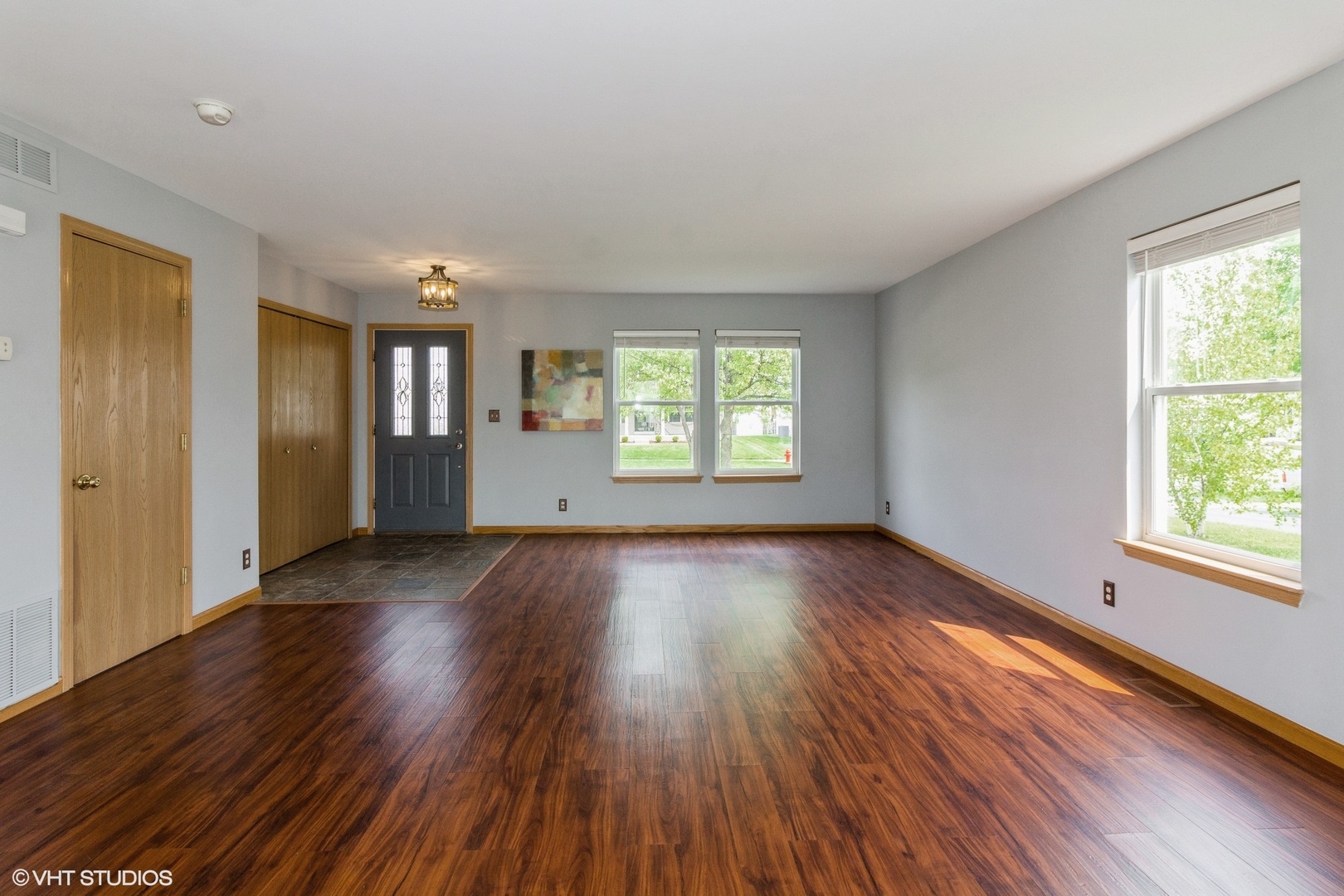 603 Kennedy Street Waterman, IL 60556 - Photo 3 of 25 an empty room with wooden floor and windows